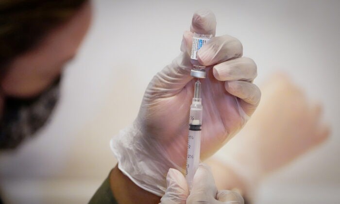 FILE PHOTO: A healthcare worker prepares a dose of the Johnson & Johnson vaccine for the coronavirus disease (COVID-19) during the opening of the MTA's public vaccination program at Grand Central Terminal train station in Manhattan in New York City, New York, U.S., May 12, 2021. REUTERS/Carlo Allegri/File Photo